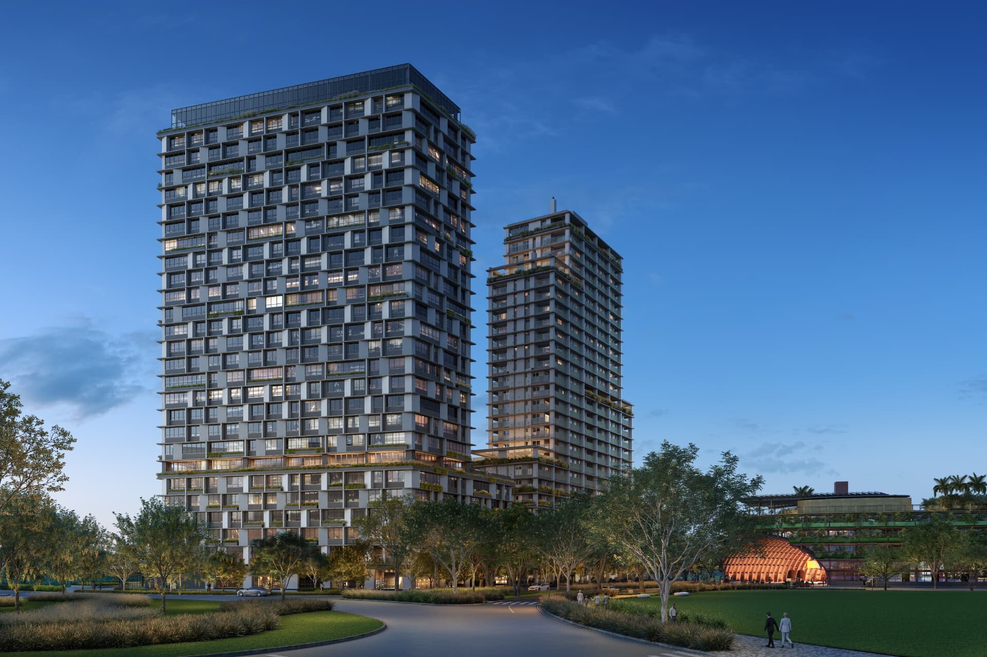 Perspectiva ilustrada do empreendimento MARTIM ao entardecer: duas torres modernas de fachada envidraçada com janelas iluminadas, rodeadas por área verde e caminhos no Bairro Parque Una, em São José dos Campos